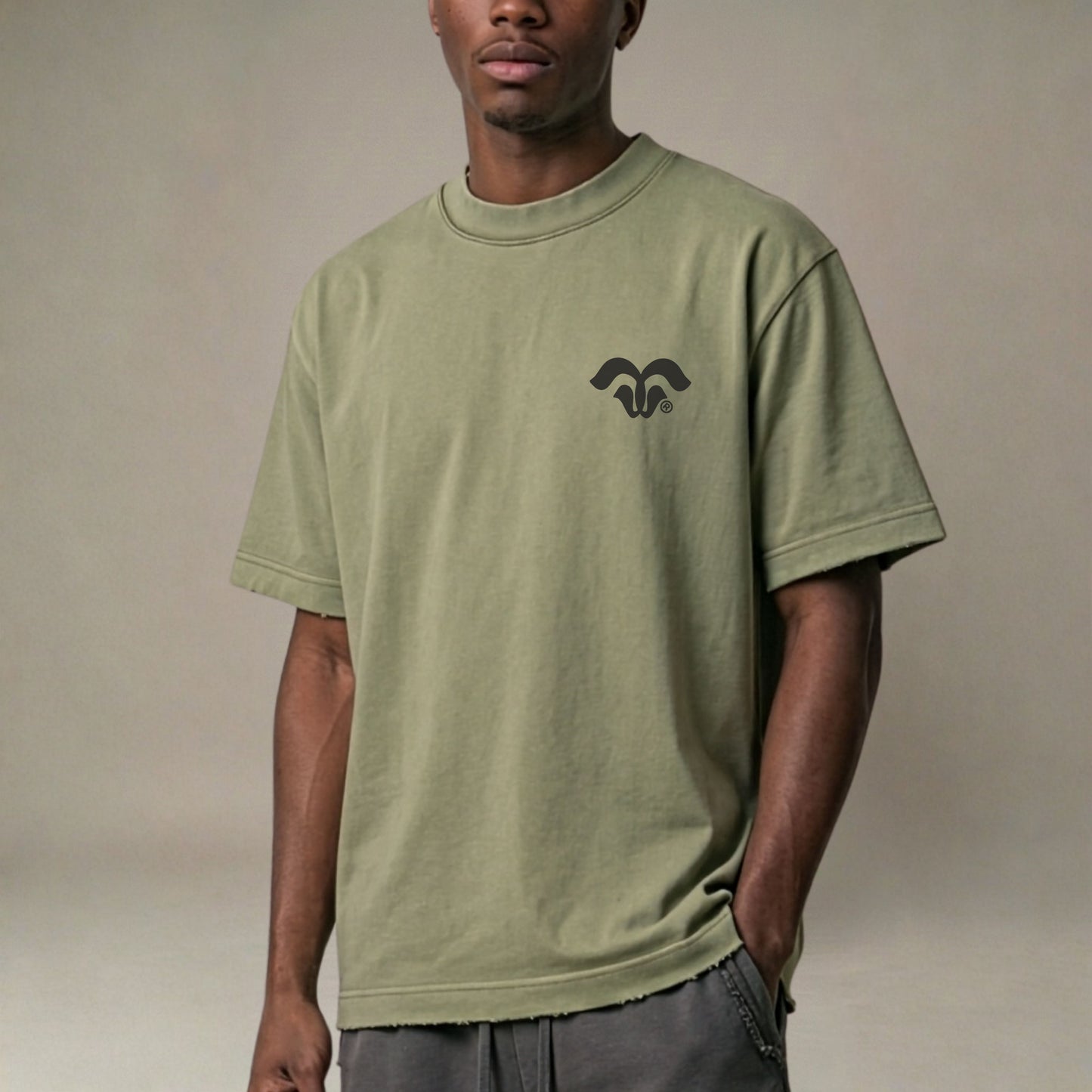 Person wearing a green t-shirt with a logo on a beige background