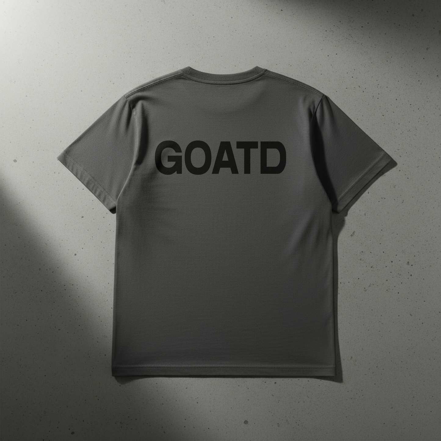 Close up shot of the back of the BORNGOATD Logo tee in Gray