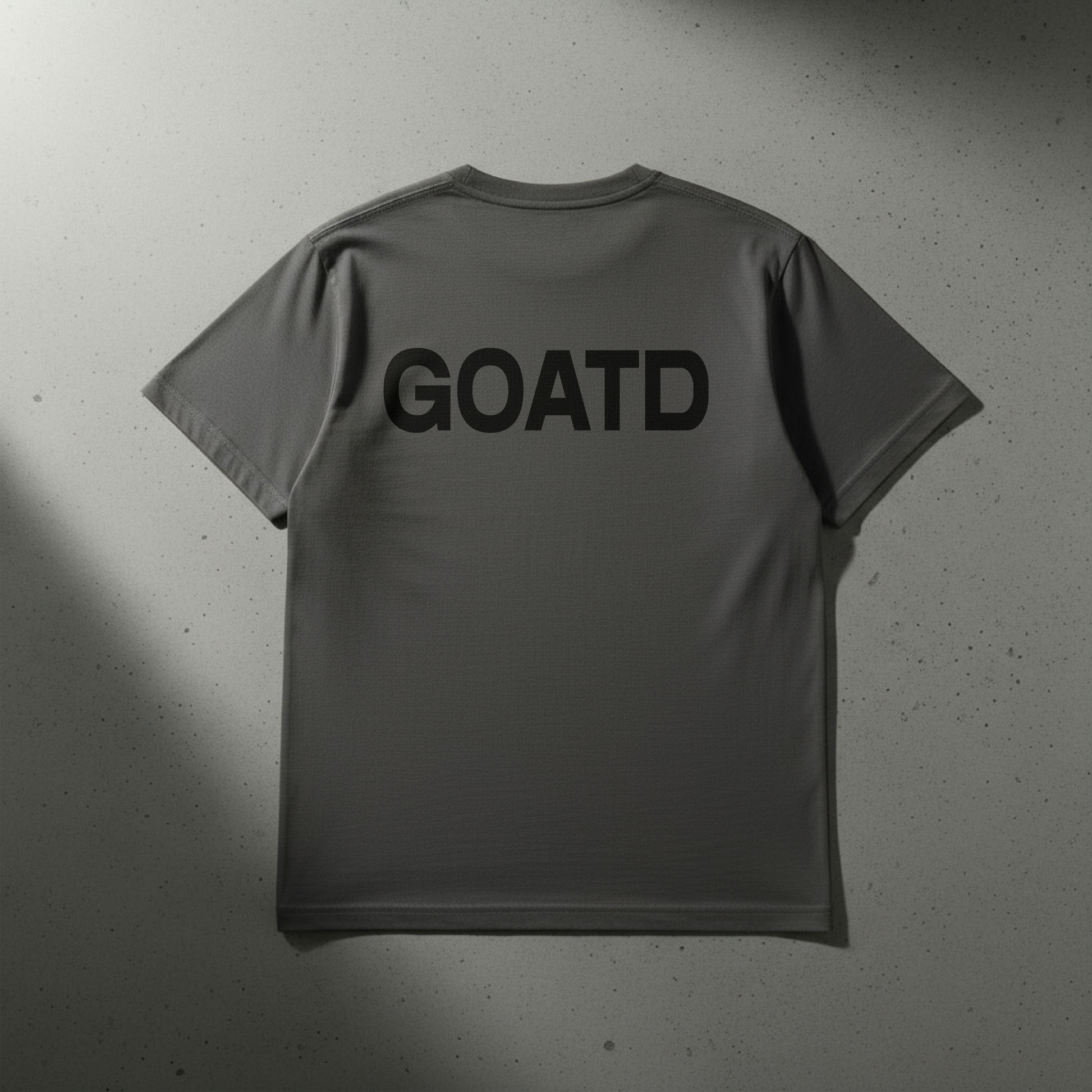 Close up shot of the back of the BORNGOATD Logo tee in Gray