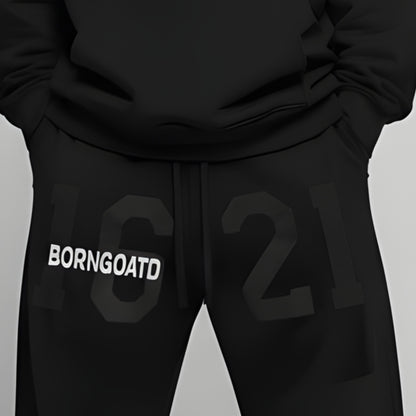 View of 1621 BORNGOATD Sweatpants showcasing large graphic and structured fit