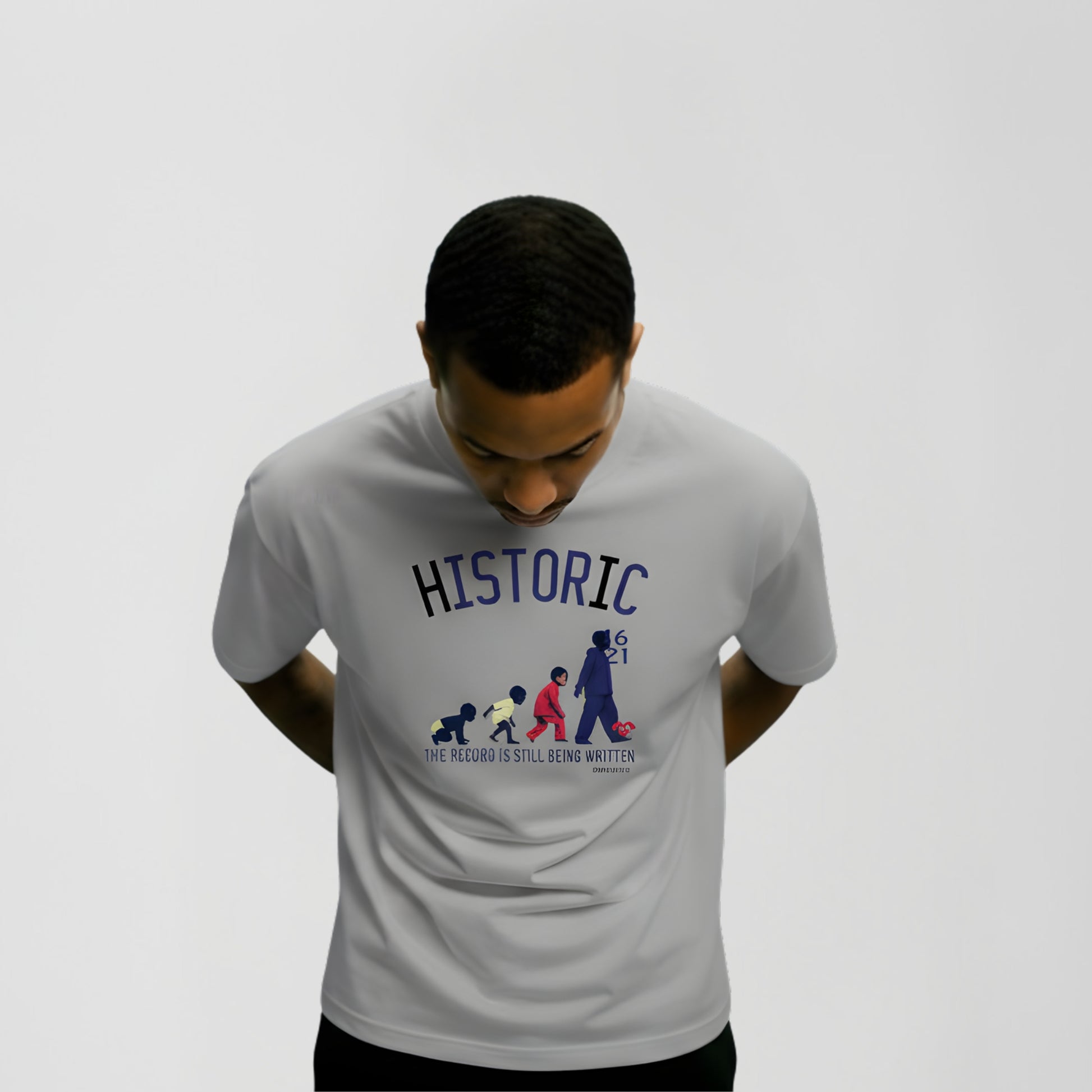 Model wearing Medium BORNGOATD Historic Evolution graphic t-shirt featuring generational progression artwork and “The Record Is Still Being Written” slogan